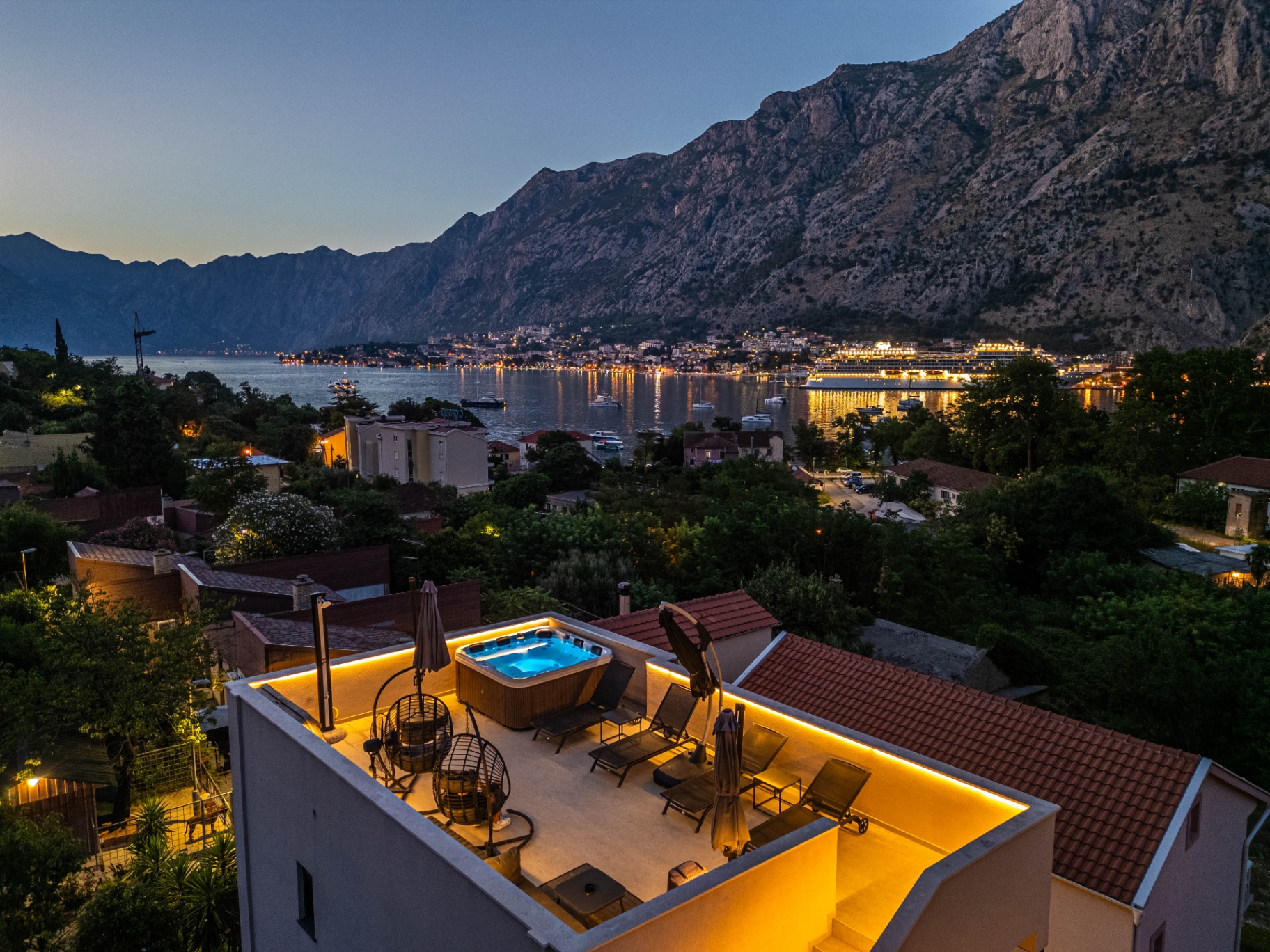 Rooftop hot tub overlooking Kotor bay at night