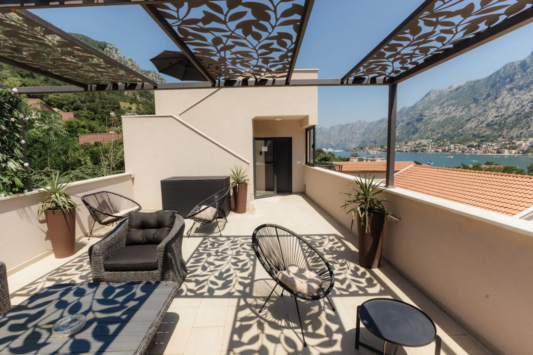 Private terrace with leaf-pattern pergola