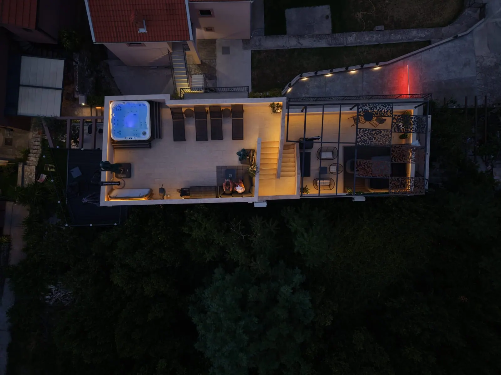 Overhead view of the rooftop deck and lounge at night
