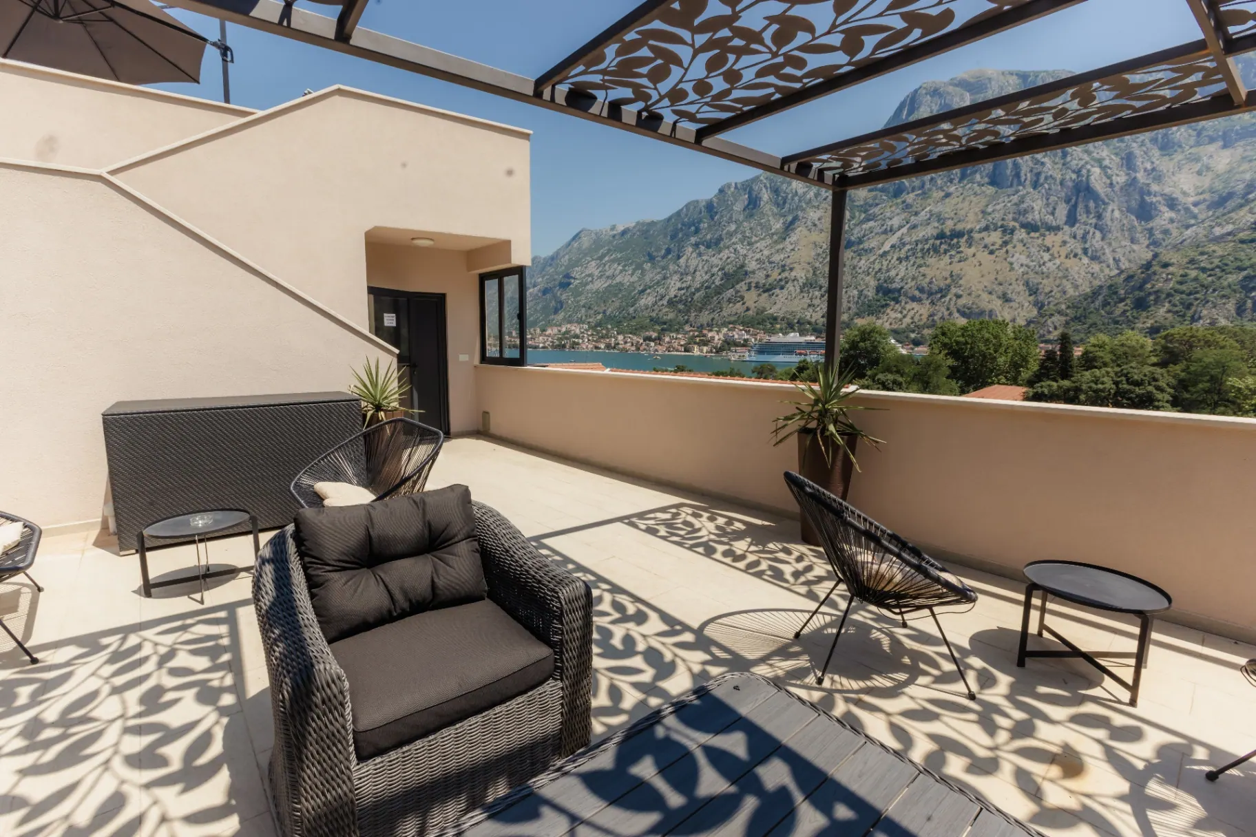 Terrace seating under decorative pergola