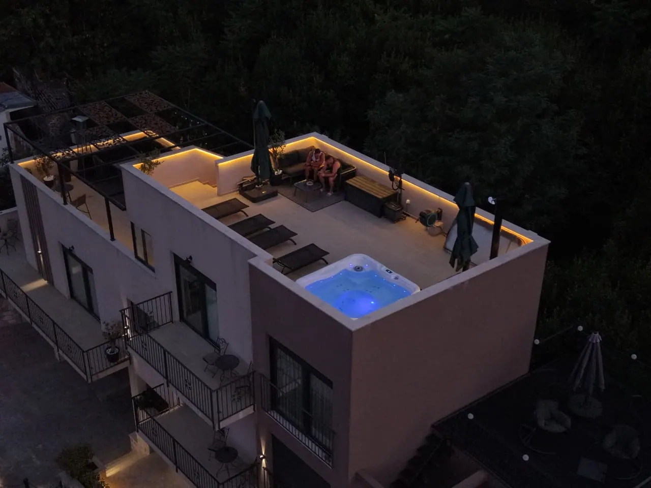 Rooftop hot tub glowing blue at night